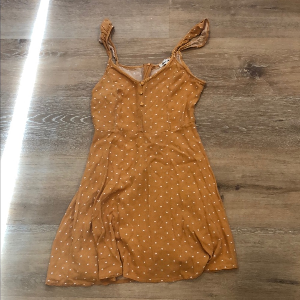 Yellow dress with white dots and some buttons